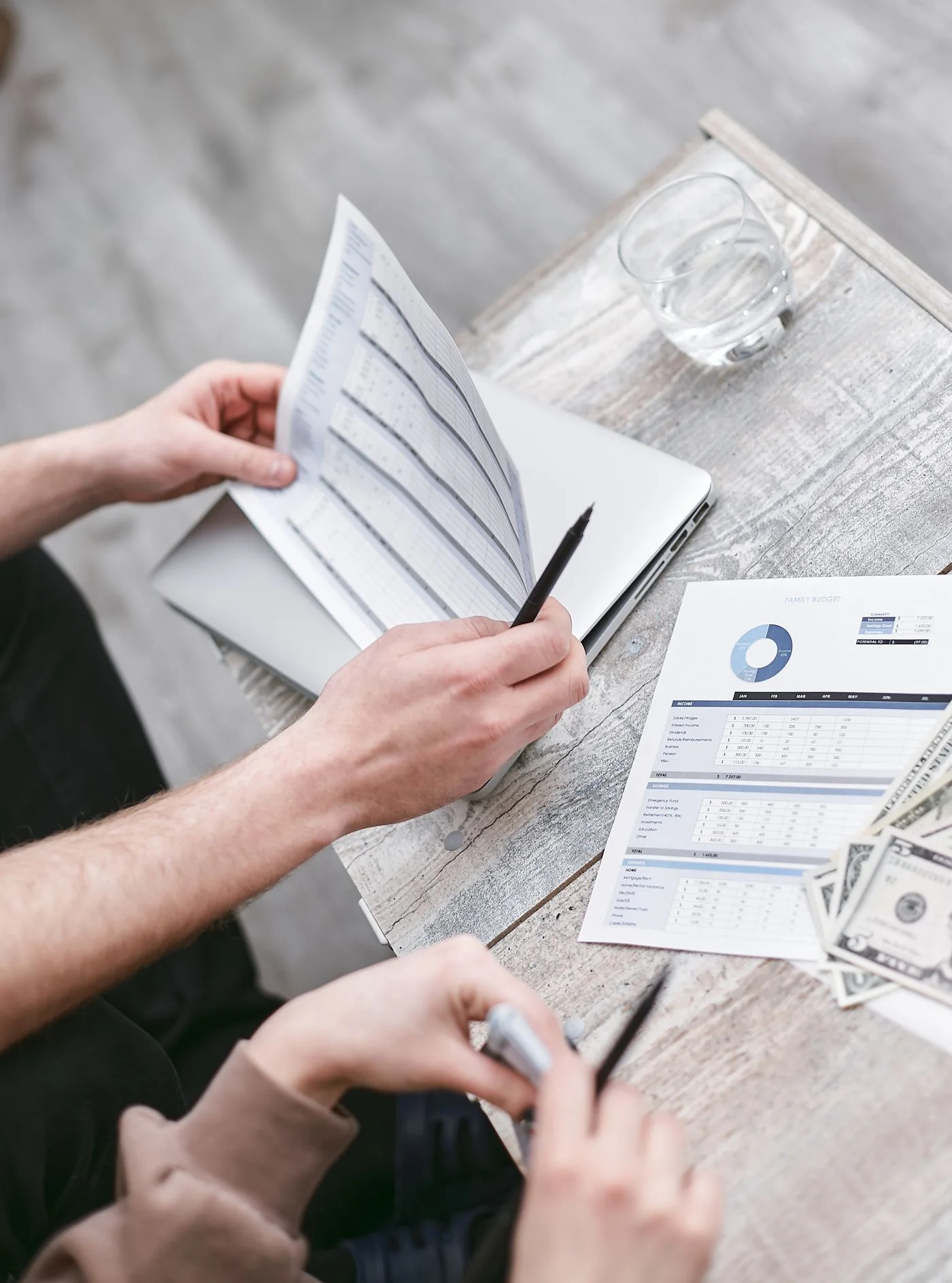 Two professionals reviewing financial documents with charts, fostering collaboration.